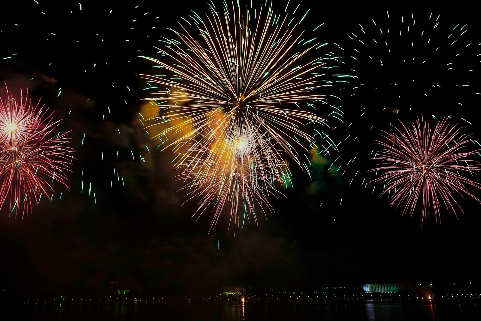 yellow and pink fireworks display in sky